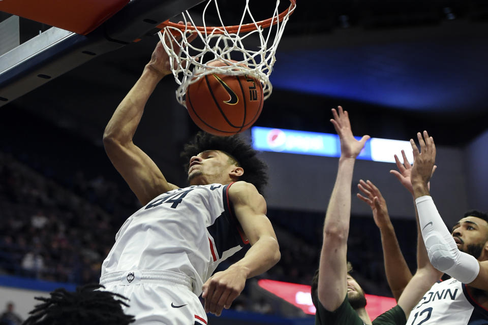 Connecticut's Andre Jackson (44) dunks during the first half of an NCAA college basketball game against Binghamton, Saturday, Nov. 20, 2021, in Hartford, Conn. (AP Photo/Stephen Dunn)