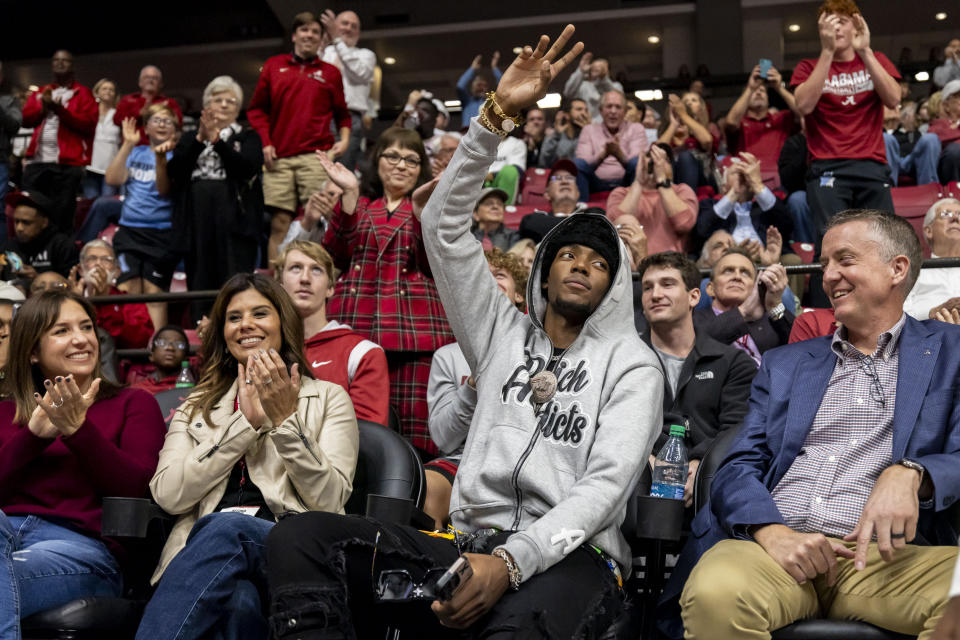 Former Alabama basketball player Brandon Miller, second from front right, waves to the crowd during the second half of an NCAA college basketball game between Alabama and Morehead State, Monday, Nov. 6, 2023, in Tuscaloosa, Ala. Miller currently plays for the Charlotte Hornets. (AP Photo/Vasha Hunt)