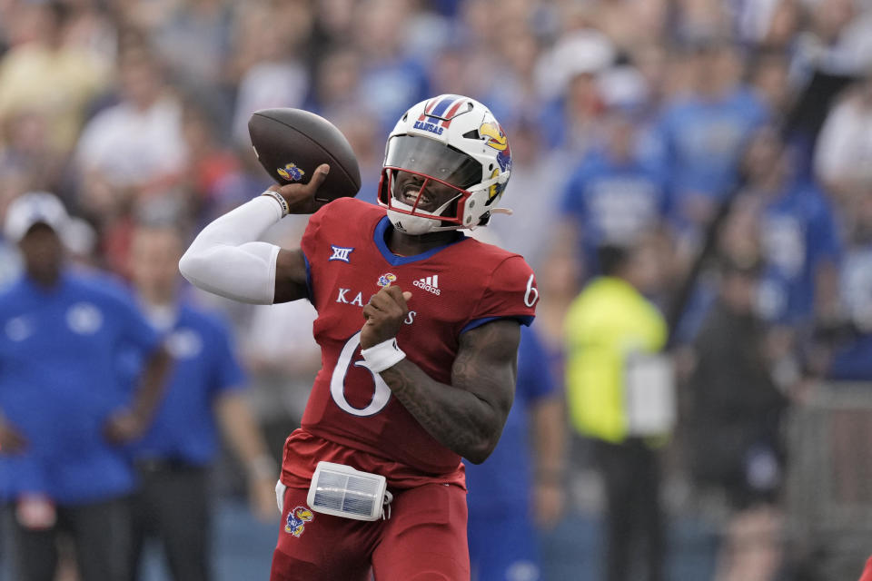 Kansas quarterback Jalon Daniels throws during the first half of an NCAA college football game against BYU Saturday, Sept. 23, 2023, in Lawrence, Kan. (AP Photo/Charlie Riedel)