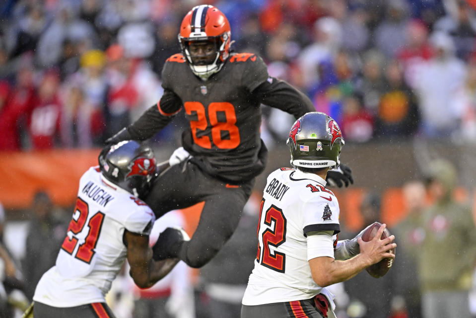 Tampa Bay Buccaneers quarterback Tom Brady (12) looks to pass with pressure coming from Cleveland Browns linebacker Jeremiah Owusu-Koramoah (28) during the second half of an NFL football game in Cleveland, Sunday, Nov. 27, 2022. The Browns won 23-17 in overtime. (AP Photo/David Richard)