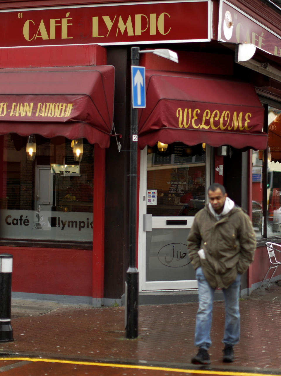 In this Friday, April 27, 2012 photo a man walks walk past the Cafe Lympic in Stratford, east London. One day, the small espresso shop near the site of the London Games was the "Olympic" cafe. The next day, it was the "Lympic." So where did the "O" go? The manager won't say. But it's more than likely the small business became another casualty in the battle against guerrilla marketers _ advertisers who try to associate their products with an event without paying to be sponsors. Protecting the Olympic brand is always a big job, and never more so than this year. Olympic organizers say the increasing sophistication of guerrilla marketers and the rise of social media are putting the five rings under assault in ways barely envisioned a decade ago. (AP Photo/Matt Dunham)