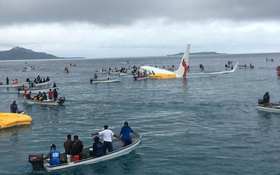 Passengers are evacuated from an Air Niugini plane that crashed in the waters in Weno - REUTERS