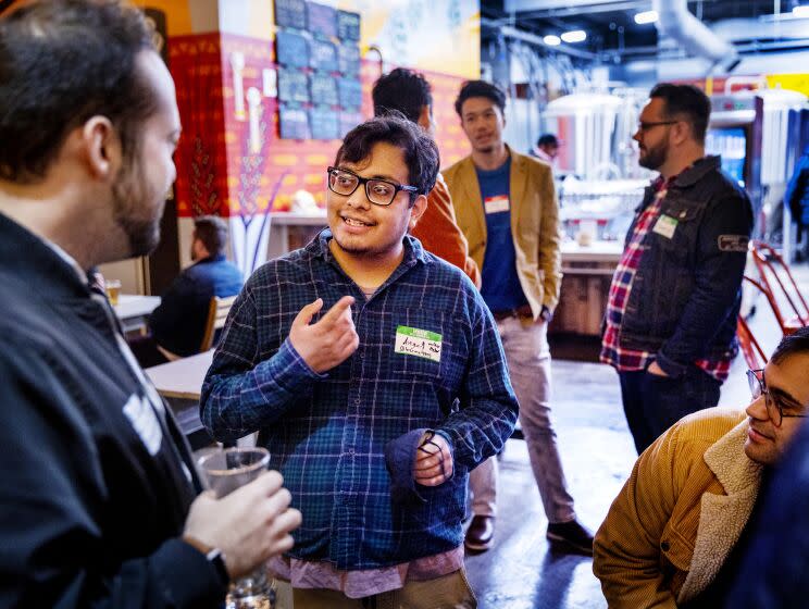 Pasadena, CA - November 15: Angel Lozano, center, a former student at East Los Angeles College, meets with a screenwriters at Cerveceria Del Pueblo in Pasadena Tuesday, Nov. 15, 2022. (Allen J. Schaben / Los Angeles Times) Lozano, who dropped out of college, is hoping to pursue his dream of becoming an actor. He's writing a movie script, but he's also worked as a cart wrangler at Target and now supervises activities at an assisted living facility.