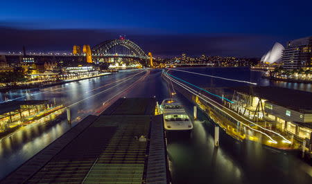Streaks of light from arriving ferries illuminate wharves at Sydney's Circular Quay terminal in this seven-minute-long time exposure at dusk, July 16, 2015. REUTERS/Jason Reed