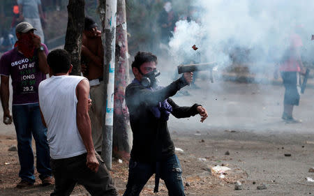 A demonstrator fires a homemade mortar towards riot police during a protest over a controversial reform to the pension plans of the Nicaraguan Social Security Institute (INSS) in Managua, Nicaragua April 21, 2018. REUTERS/Oswaldo Rivas