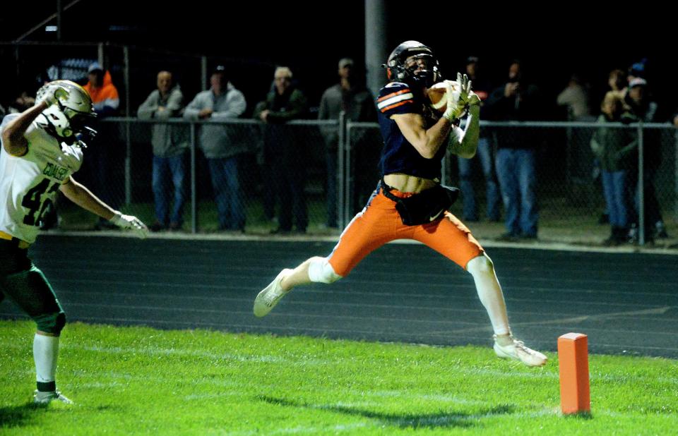Rochester's Henry Buecker catches a pass and then runs for a touchdown during the game against Coal City Friday, Nov. 3, 2023.