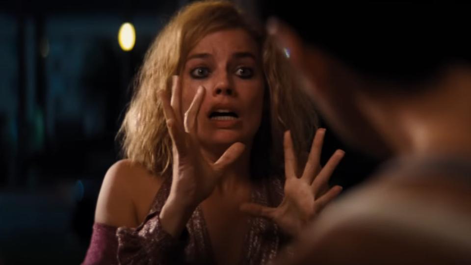 Margot Robbie pleads in front of Diego Calva's doorstep in Babylon.