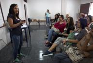 In this Aug. 26, 2018 photo, Marialbert Barrios speaks to a group of women at an empowerment workshop, in the Catia neighborhood of Caracas, Venezuela. Twenty-eight-year-old Barrios is the National Assembly's youngest member. (AP Photo/Ariana Cubillos)