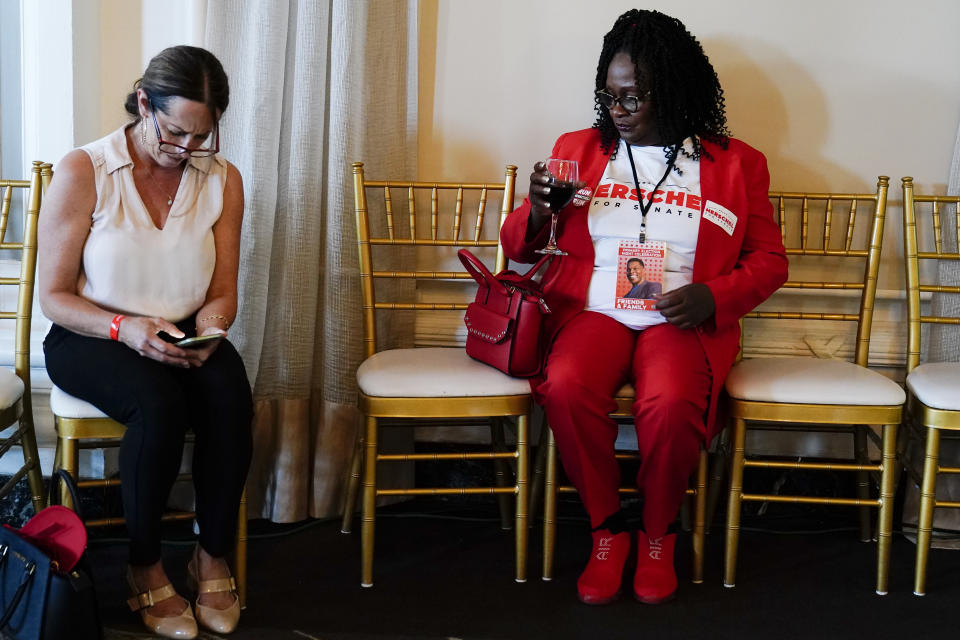 Monica Kinnebrew, of Perry Ga., left, and Krystal Daniel, of Atlanta, await U.S. Senate candidate Herschel Walker during an election night watch party, Tuesday, May 24, 2022, in Atlanta.(AP Photo/Brynn Anderson)