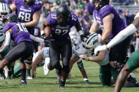 Northwestern running back Anthony Tyus III (27) runs with the ball past Ohio linebacker Cannon Blauser during the second half of an NCAA college football game in Evanston, Ill., Saturday, Sept. 25, 2021. Northwestern won 35-6. (AP Photo/Nam Y. Huh)