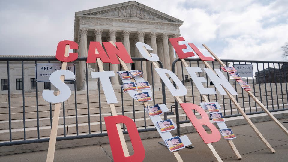 A sign calling for student loan debt relief is seen in front of the Supreme Court as the justices are scheduled to hear oral arguments in two cases involving President Joe Biden's bid to reinstate his plan to cancel billions of dollars in student debt in Washington, DC, in February. - Nathan Howard/Reuters