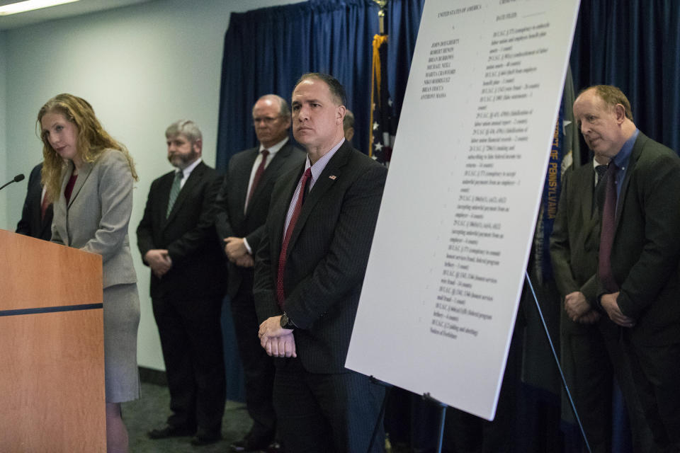 Jennifer Arbittier Williams, left, assistant United States Attorney with the Criminal Division of the U.S. Attorney's Office in Philadelphia along with Guy Ficco, right, of the IRS, and other attorneys listen to questions during a press conference on the indictment of Local 98 leader John "Johnny Doc" Dougherty at the U.S. Attorney's office in Center City Philadelphia on Wednesday, Jan. 30, 2019. Dougherty, a powerful union boss who has long held a tight grip on construction jobs in the Philadelphia region and wielded political power in the city and Statehouse, was indicted on embezzlement and fraud charges along with a city councilman and six others. (Heather Khalifa/The Philadelphia Inquirer via AP)