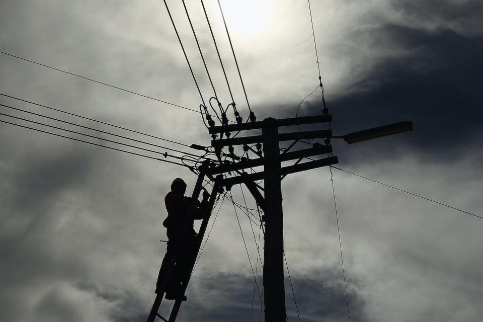Overhead power lines are also a risk to the workers who fix them after storm damage. Getty Images