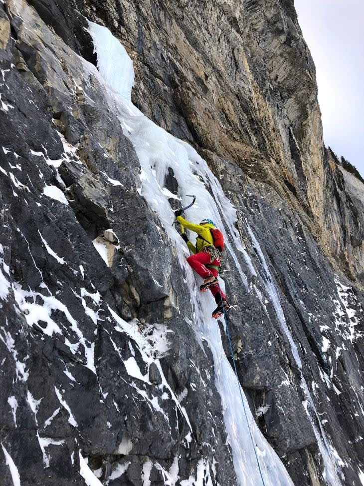 Ice climber leads a pitch of ice in Canada.