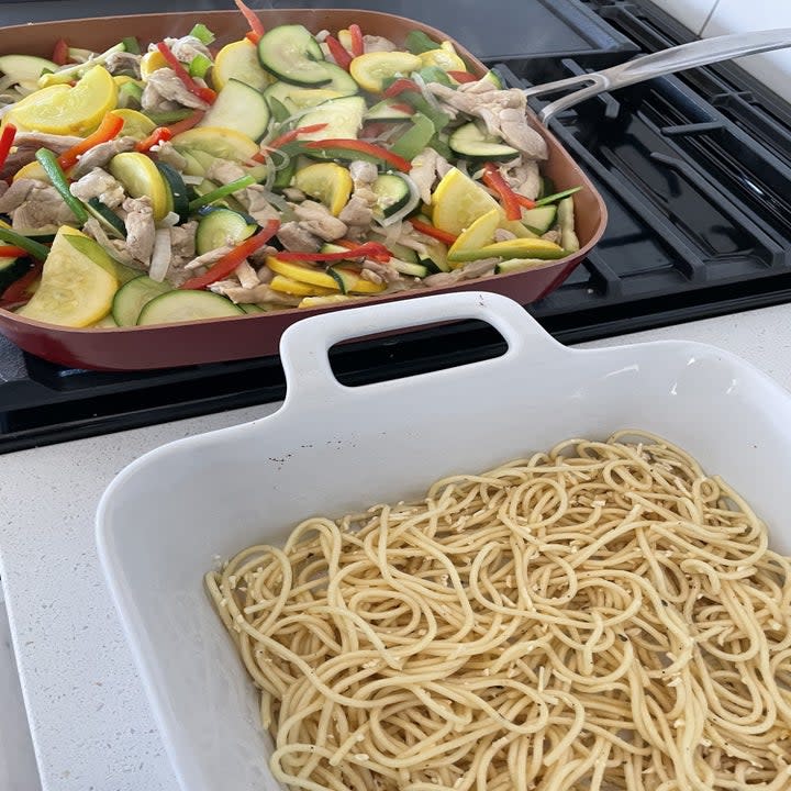 veggies cooking on the stove with noodles