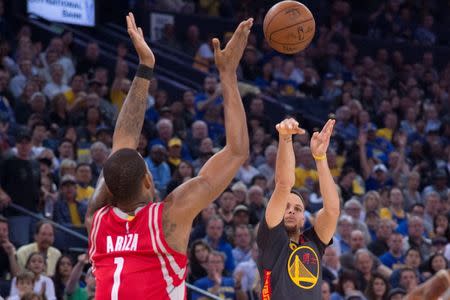 February 9, 2016; Oakland, CA, USA; Golden State Warriors guard Stephen Curry (30) shoots the basketball against Houston Rockets forward Trevor Ariza (1) during the third quarter at Oracle Arena. The Warriors defeated the Rockets 123-110. Mandatory Credit: Kyle Terada-USA TODAY Sports