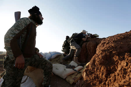 Rebel fighters from 'Jaysh al-Sunna' stand on a look-out point in the southern Aleppo countryside, Syria June 10, 2016. REUTERS/Khalil Ashawi