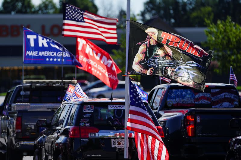 Vehicles fly pro-Trump flags prior to participating in a caravan convoy in Dunwoody