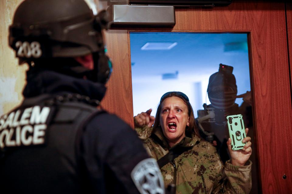 <p>A protester screams at Salem police during the demonstration</p>AP