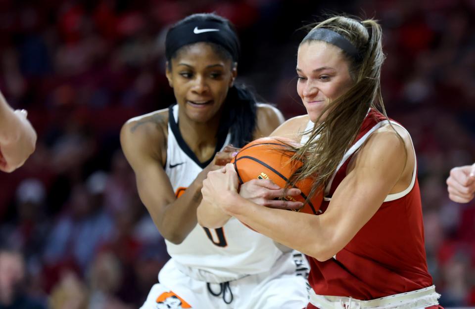 Oklahoma's Lexy Keys (15) gets a tie ball with Oklahoma State's Quincy Noble (0) in the first half of the women's Bedlam basketball game between the Oklahoma State Cowgirls and the the University of Oklahoma Sooners at Lloyd Noble Center in Norman, Okla., Saturday, Feb. 24, 2024.