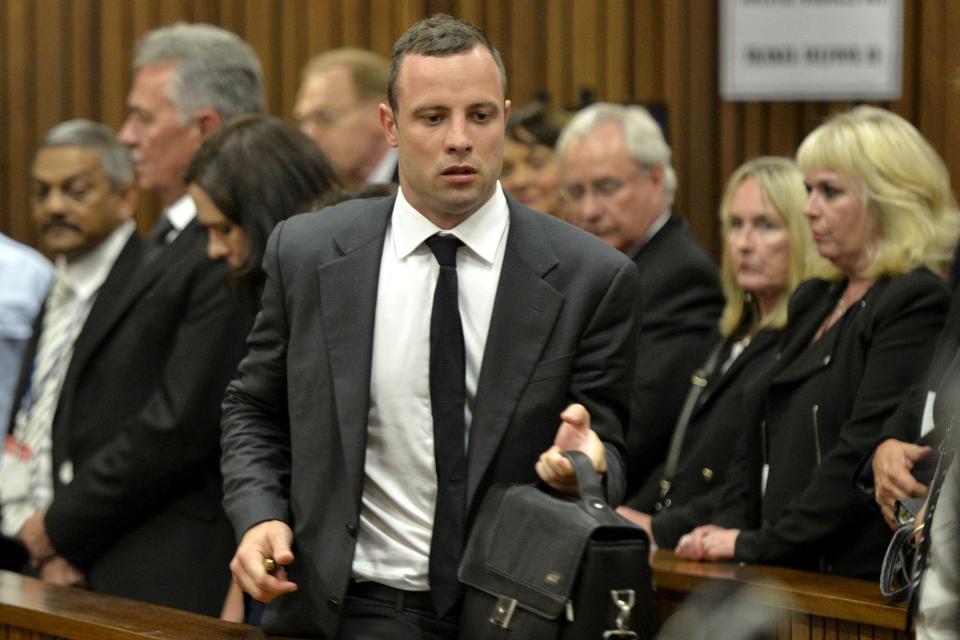 Olympic and Paralympic track star Oscar Pistorius arrives back in court after a lunch break during his trial at the North Gauteng High Court in Pretoria, March 3, 2014.The first witness at Pistorius' murder trial told the court on Monday she heard "bloodcurdling screams" from a woman followed by shots, a dramatic opening to a case that could see one of global sports' most admired role models jailed for life. Pistorius pleaded not guilty to murdering his girlfriend, model Reeva Steenkamp, on Valentine's Day last year. REUTERS/Herman Verwey/Pool (SOUTH AFRICA - Tags: SPORT ATHLETICS ENTERTAINMENT CRIME LAW)