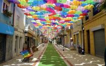 <p>This tiny street in northwest Portugal has become the subject of many Instagram posts, thanks to the colorful umbrellas providing shade to passersby.</p>