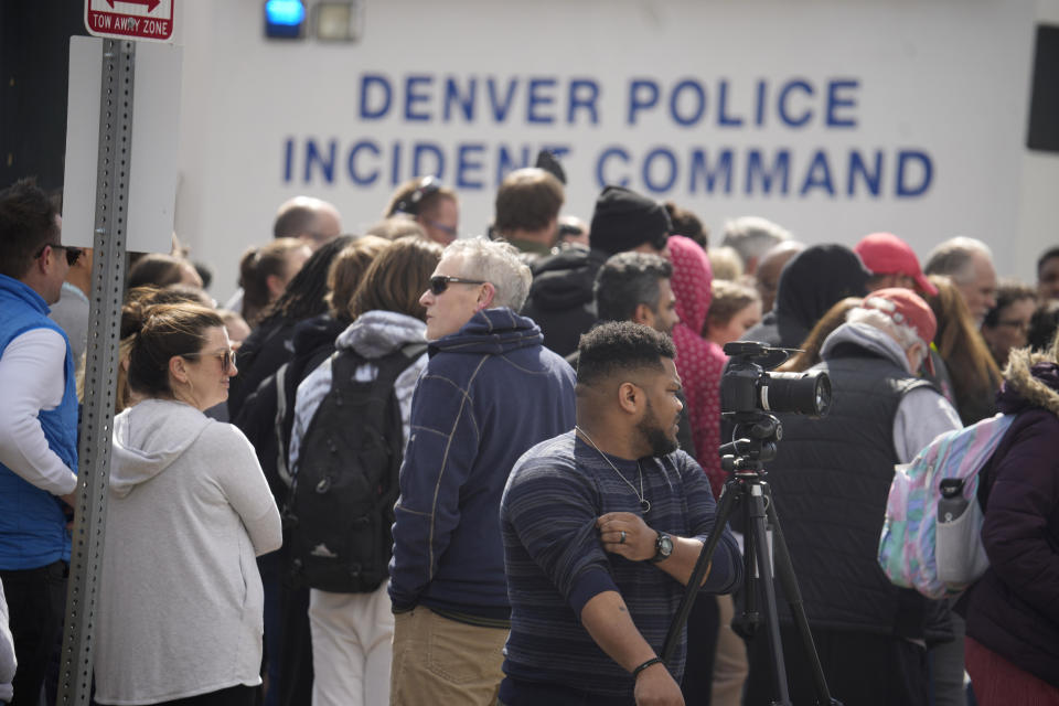 Parents wait for students to be walked out after two administrators were shot and wounded after a handgun was found during a daily search of a student at Denver's East High School on March 22, 2023. / Credit: AP Photo/David Zalubowski