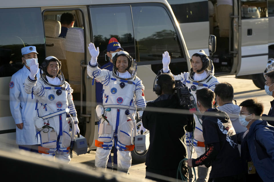 Chinese astronauts, from left, Liu Boming, Nie Haisheng, and Tang Hongbo wave as they prepare to board for liftoff at the Jiuquan Satellite Launch Center in Jiuquan in northwestern China, Thursday, June 17, 2021. China plans on Thursday to launch three astronauts onboard the Shenzhou-12 spaceship who will be the first crew members to live on China's new orbiting space station Tianhe, or Heavenly Harmony. (AP Photo/Ng Han Guan)