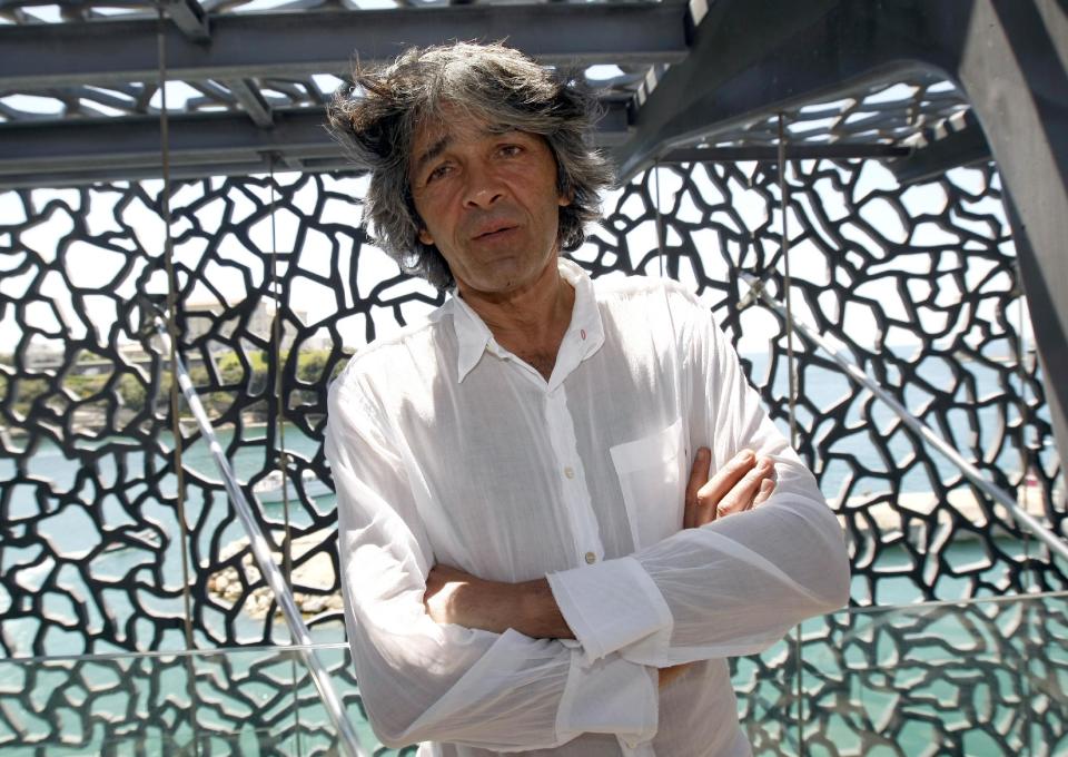 In this photo taken Monday June 3, 2013, architect Rudy Ricciotti poses on the terrace of the Museum of European and Mediterranean Civilizations at the Fort Saint-Jean, in Marseille, southern France. The museum that cost over 200 million euros ($260 million), is being inaugurated by French President Francois Hollande on Tuesday, and is the center piece of Marseille's turn as the European Capital of Culture for 2013, which aims to attract 10 million visitors this year. (AP Photo/Claude Paris)