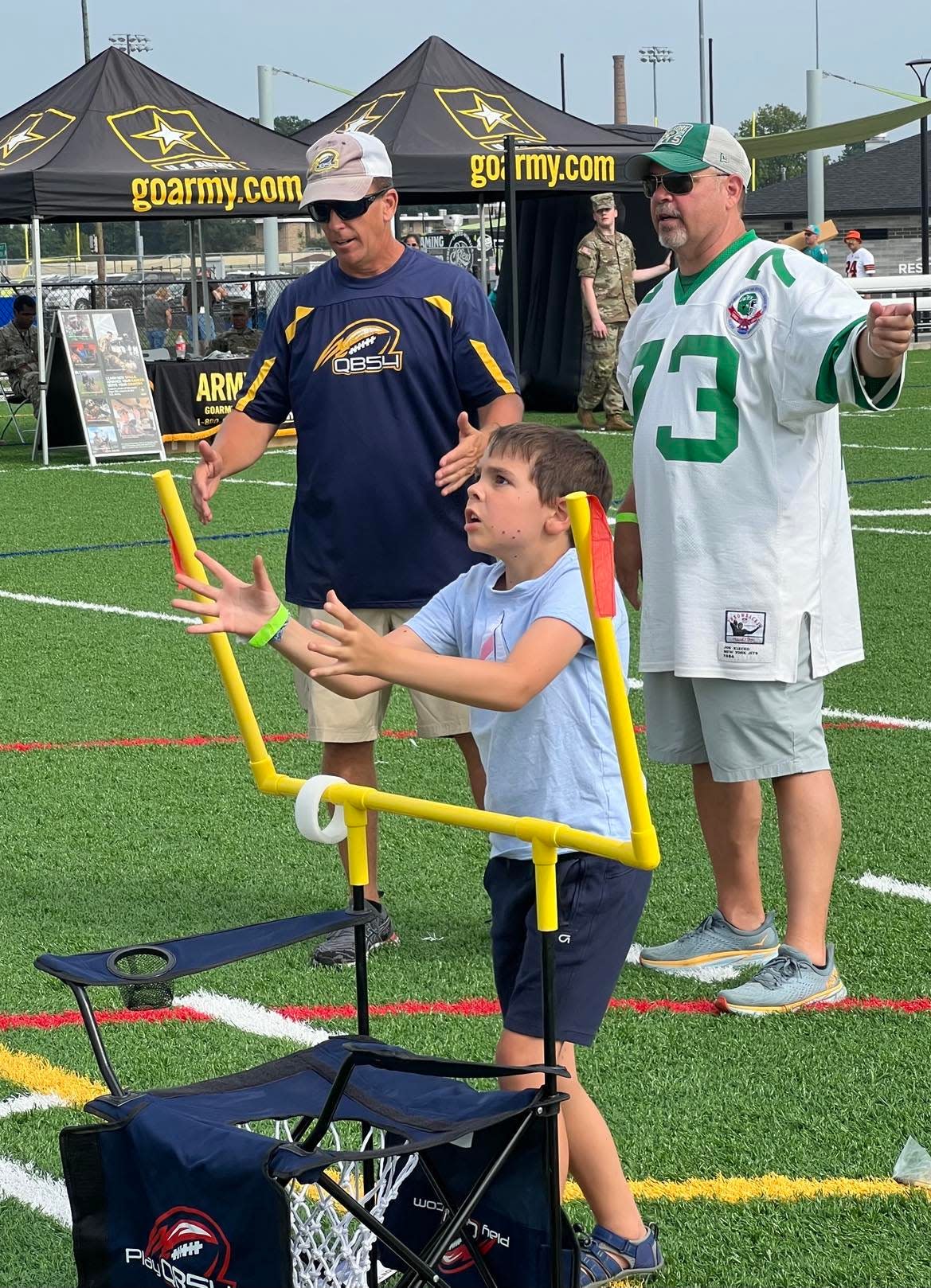 A young football fan has fun at the Hall of Fame Village during the 2023 Pro Football Hall of Fame Enshrinement Festival.