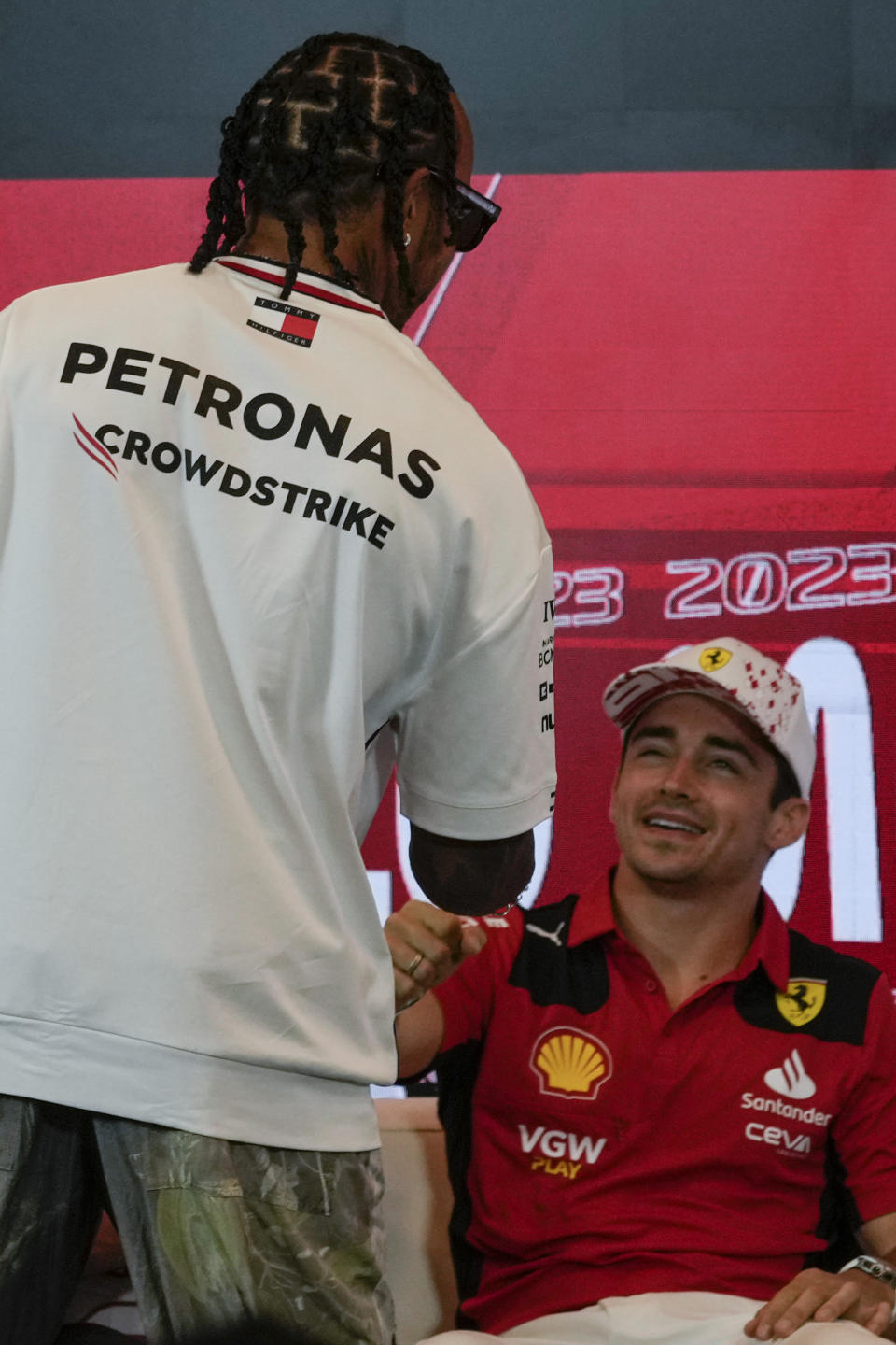 Mercedes driver Lewis Hamilton of Britain greets Ferrari driver Charles Leclerc of Monaco during a news conference at the Monaco racetrack, in Monaco, Thursday, May 25, 2023. The Formula one race will be held on Sunday. (AP Photo/Luca Bruno)