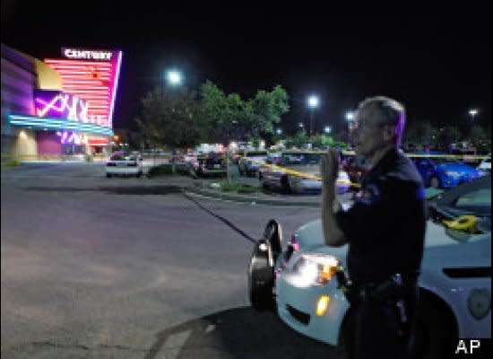 A policeman stands outside a Century 16 movie theater in Aurora, Colo., where a heavily armed man opened fire, killing at least 12 people and injuring 50 others.