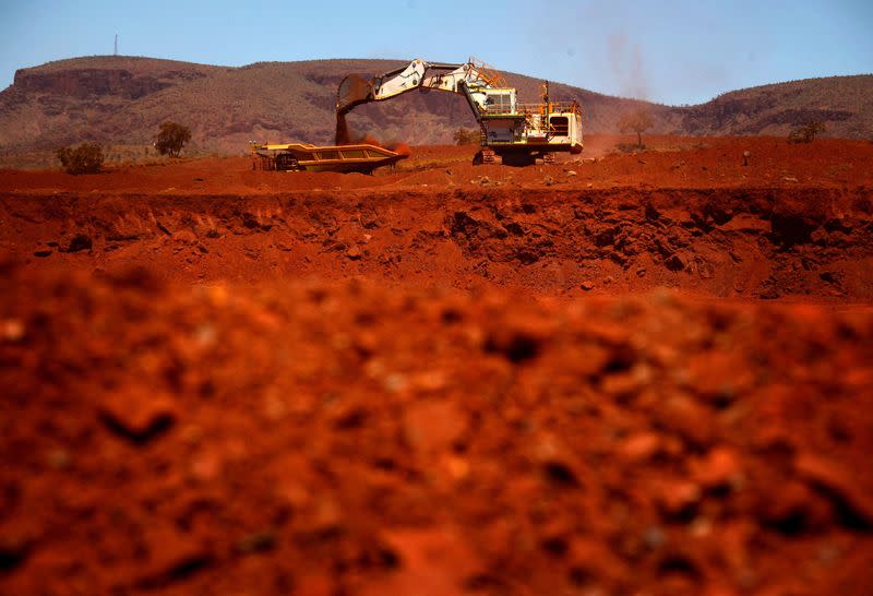 FILE PHOTO: A giant excavator loads a mining truck at the Fortescue Solomon iron ore mine south of Port Hedland