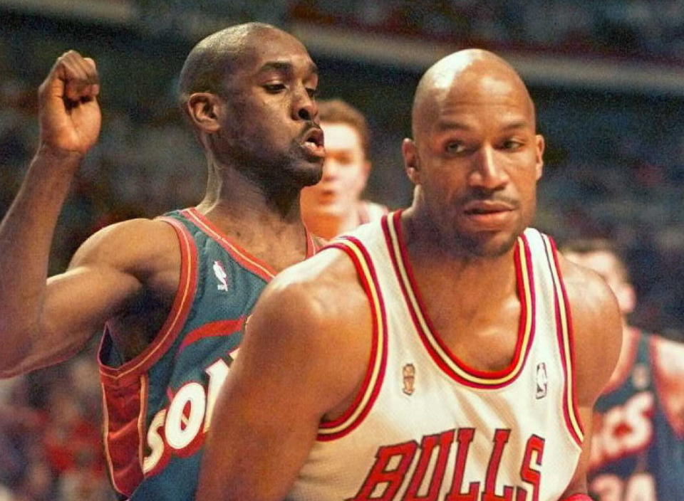 It was just like old times for Gary Payton and Ron Harper when they sat down to help kids make Valentines. (JEFF HAYNES/AFP/Getty Images)