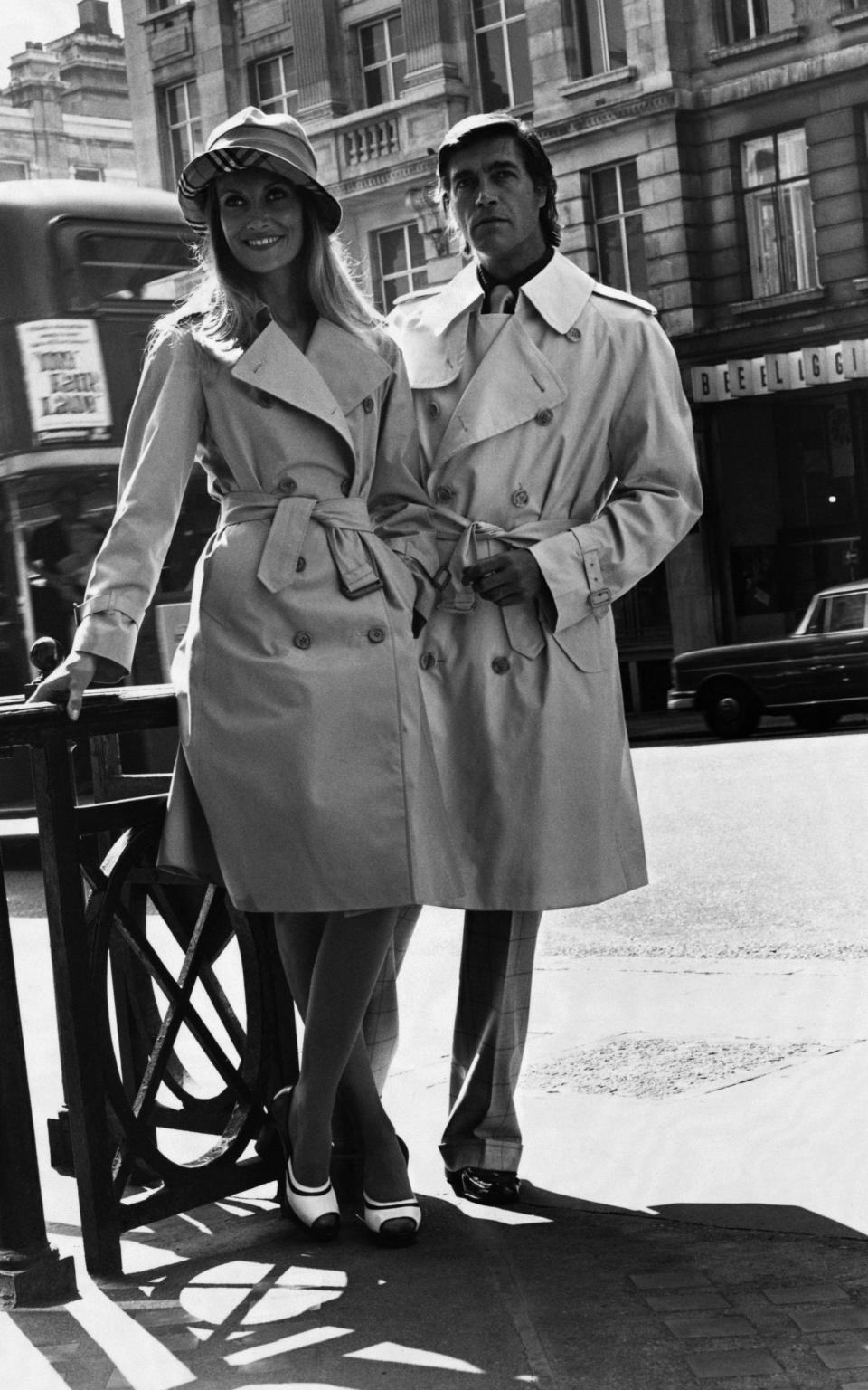 Models wearing classic 'functional and chic' Burberry raincoats in London in 1974