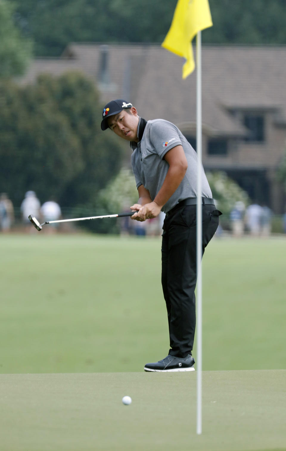 Byeong Hun An watches his putt on the first hole hole during the third round of the Wyndham Championship golf tournament at Sedgefield Country Club in Greensboro, N.C. Saturday, Aug. 3, 2019. (AP Photo/Chris Seward)