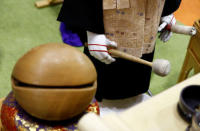 A 'robot priest' wearing a Buddhist robe holds a stick to beat a wooden fish during its demonstration at Life Ending Industry EXPO 2017 in Tokyo, Japan August 23, 2017. REUTERS/Kim Kyung-Hoon