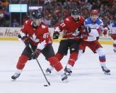 Sep 24, 2016; Toronto, Ontario, Canada; Team Canada forward Sidney Crosby (87) looks to make a play as forward Patrice Bergeron (37) holds off Team Russia forward Evgeny Kuznetsov (92) during a semifinal game in the 2016 World Cup of Hockey at Air Canada Centre. Mandatory Credit: John E. Sokolowski-USA TODAY Sports