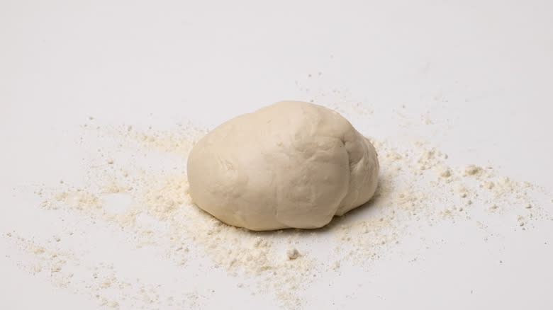 ball of dough on flour