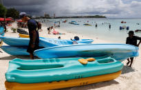 <p>Tourists frolic along the Tumon beach on the island of Guam, a U.S. Pacific Territory, August 10, 2017. (Erik De Castro/Reuters) </p>