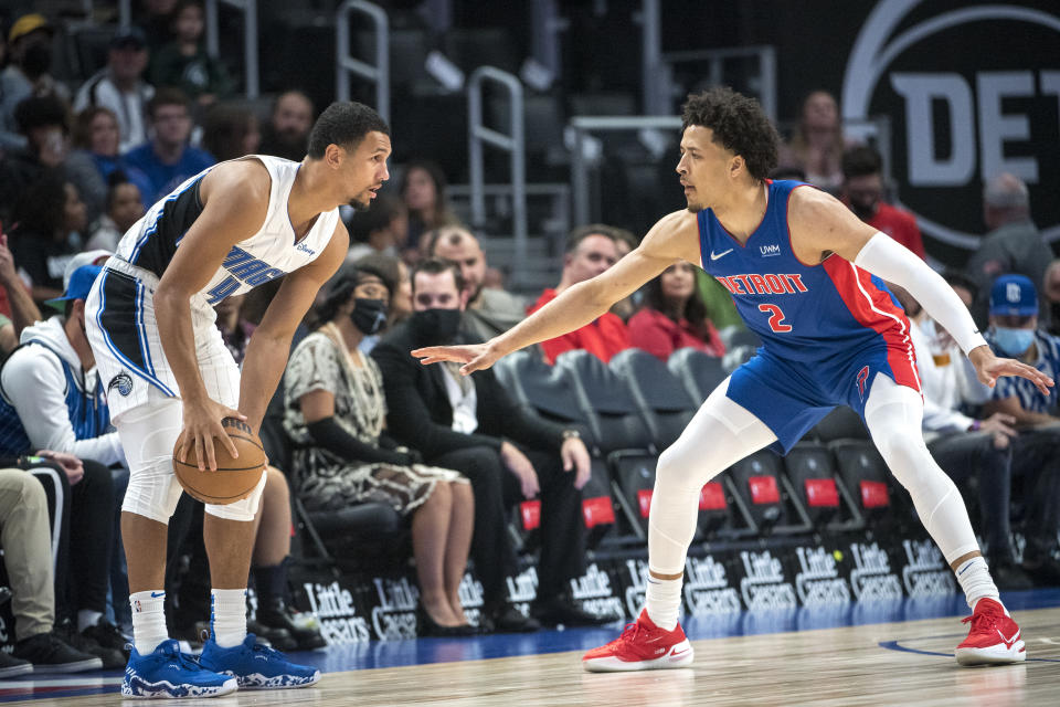 Cade Cunningham covers Jalen Suggs, who has the ball in his hands.