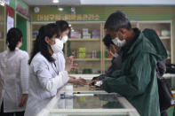 Employees of the Medicament Management Office of the Daesong District in Pyongyang provide medicine to residents as the state increases measures to stop the spread of illness in Pyongyang, North Korea, Monday, May 16, 2022. (AP Photo/Jon Chol Jin)