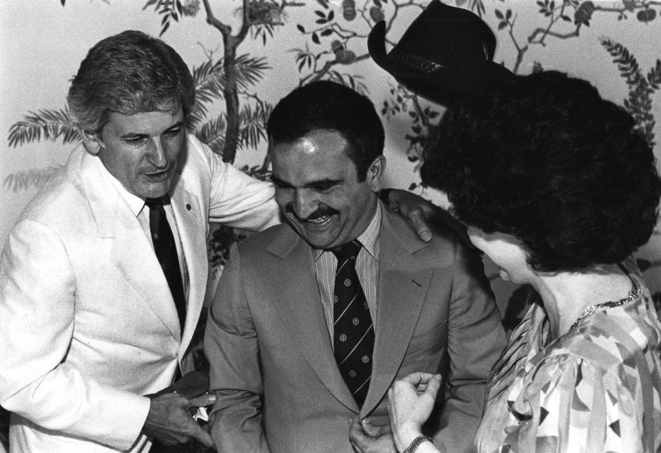 In a May, 22, 1982, photograph, World's Fair board chairman Jake Butcher, left, and his wife, Sonya, welcome Crown Prince Hassan of Jordan to Knoxville. Hassan was presented with a cowboy hat. (KNS Archive)