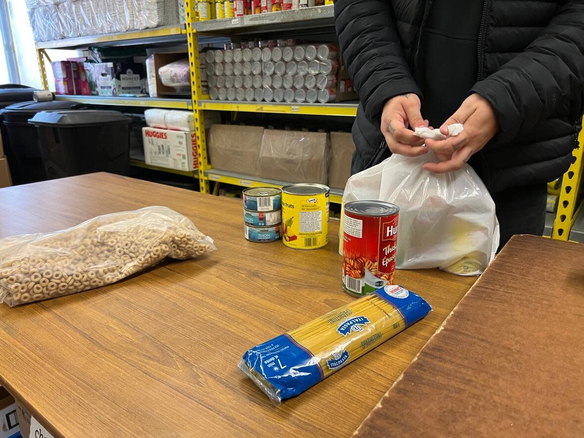 Low social assistance rates in Nova Scotia are creating great hardships for the least fortunate in the province, MLAs in Halifax heard Tuesday. A food bank package being prepared, above. (Aura Carreño Rosas/CBC - image credit)