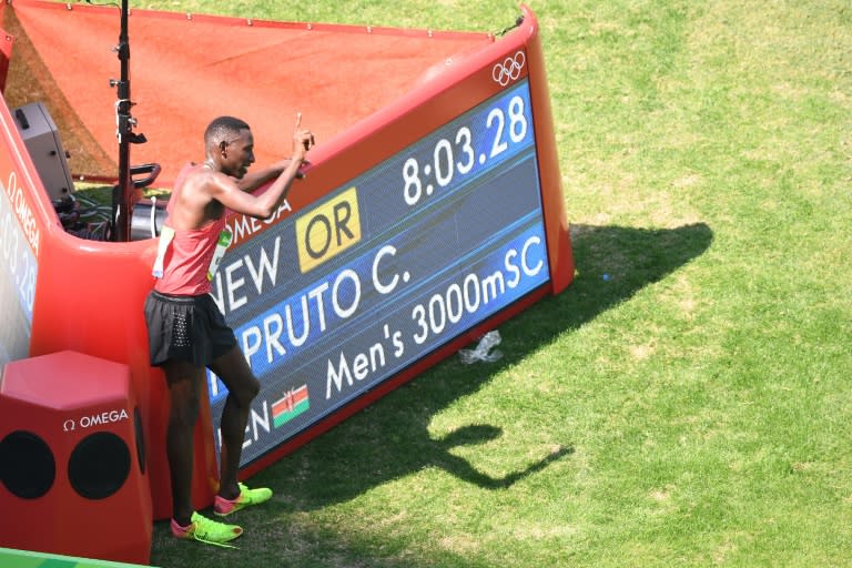 Kenya's Conseslus Kipruto celebrates his new Olympic record time on his way to victory in the men's 3000m steeplechase in Rio on August 17, 2016