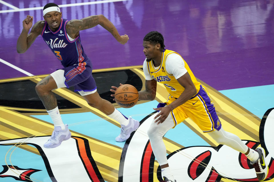 Los Angeles Lakers forward Cam Reddish (5) drives as Phoenix Suns guard Bradley Beal (3) defends during the during the second half of an NBA basketball in-season tournament game, Friday, Nov. 10, 2023, in Phoenix. (AP Photo/Matt York)