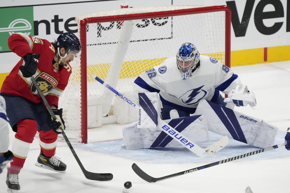 Florida Panthers left wing Ryan Lomberg (94) attempts a shot at Tampa Bay Lightning goaltender Andrei Vasilevskiy (88) during the third period of an NHL hockey game, Monday, Feb. 6, 2023, in Sunrise, Fla. (AP Photo/Wilfredo Lee)