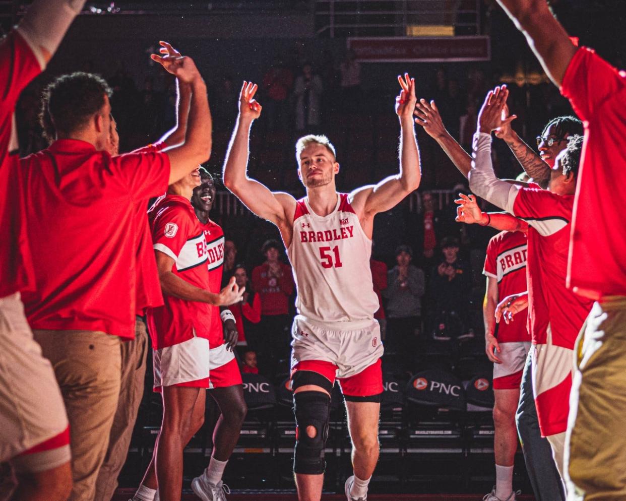 Bradley center Rienk Mast is greeted by his teammates as he returned from a knee injury to make his season debut during the Braves 83-41 blowout win over Merrimack at Carver Arena on Saturday, Nov. 26, 2022.