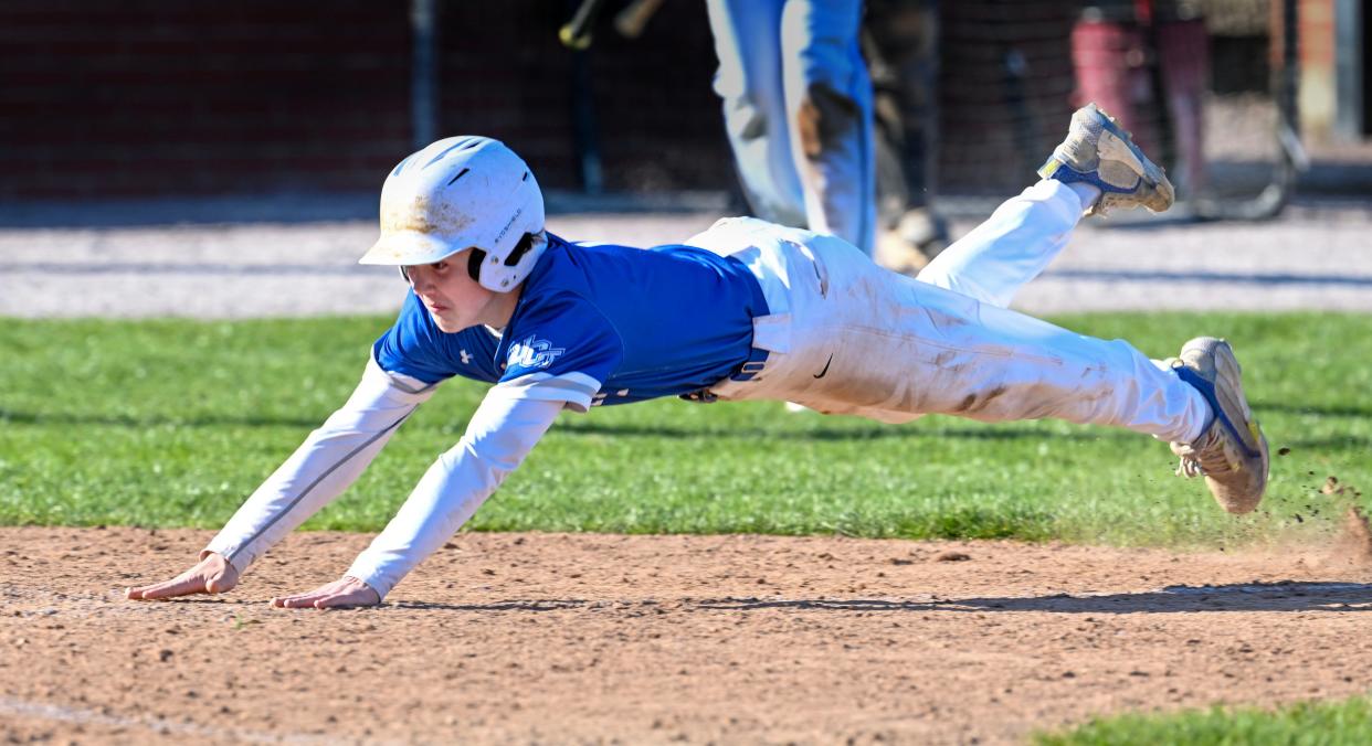 Mitchell Kirkland of Upper Cape Tech dives across home tying the game on Monday against Sturgis at 2.