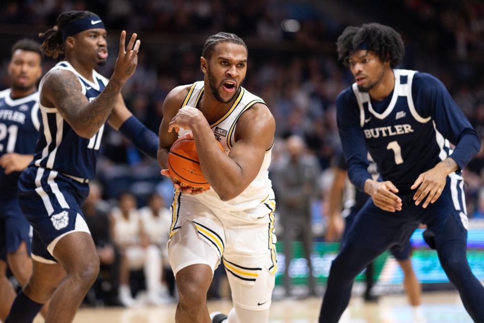 Villanova Wildcats forward Eric Dixon (43) controls the ball against Butler Bulldogs guard Jahmyl Telfort (11) and forward Jalen Thomas (1) during the second half at William B. Finneran Pavilion. Both teams are on the bubble for the NCAA Tournament.